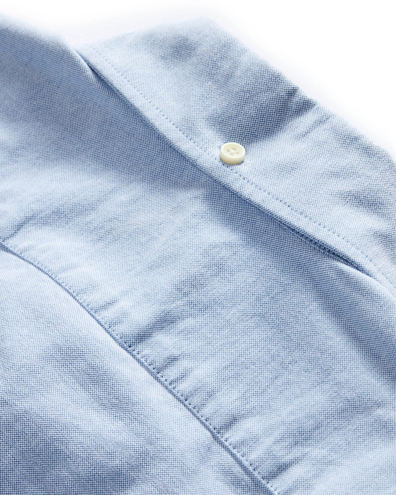 Oxford workshirt fabric texture and button detail in sky blue